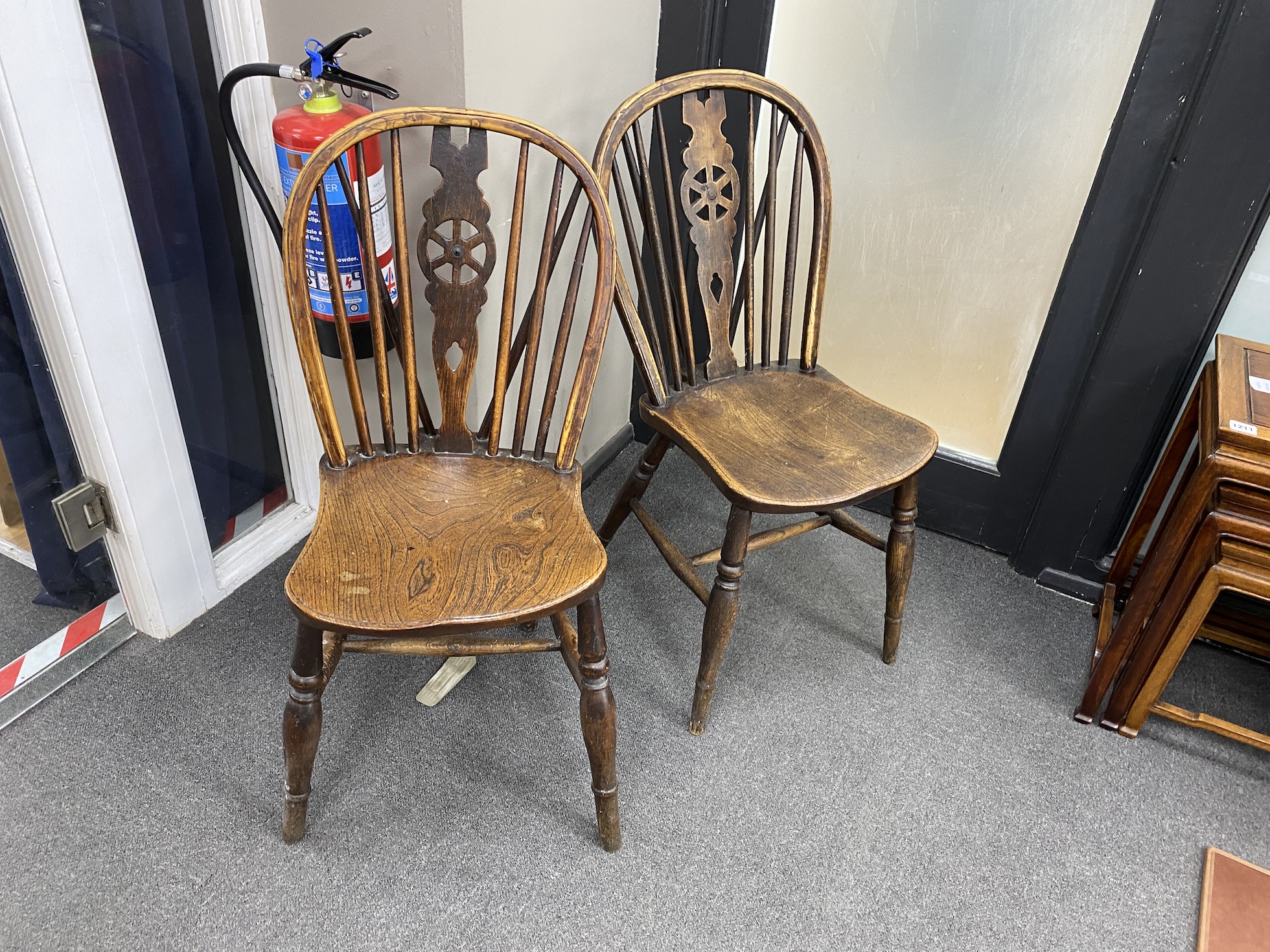 A harlequin set of ten 19th century ash and elm Windsor wheelback dining chairs, two with arms